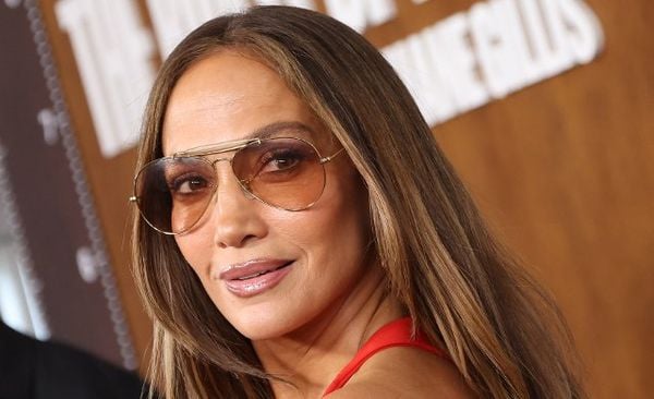 Jennifer Lopez exudes effortless glamour with a radiant smile and chic sunglasses.