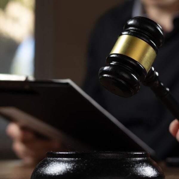 Judge with paper document pronouncing sentence