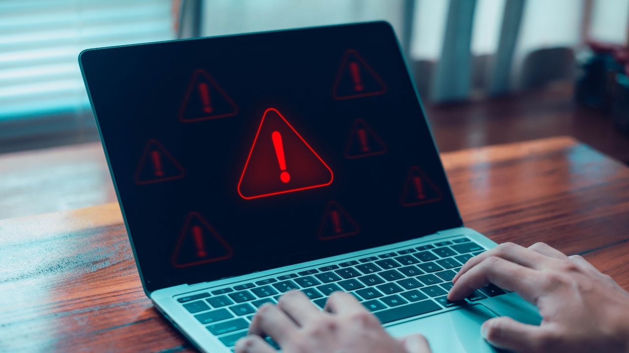 Laptop screen showing a red warning alert