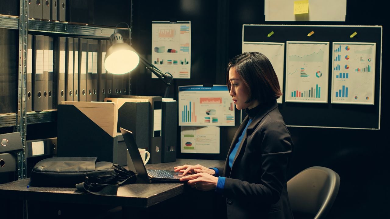 Detective reviewing fraud evidence