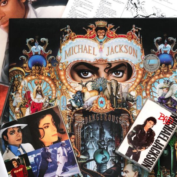 Close up of vinyl lp Dangerous of Michael Jackson,cds and audio cassette tape over blue background.