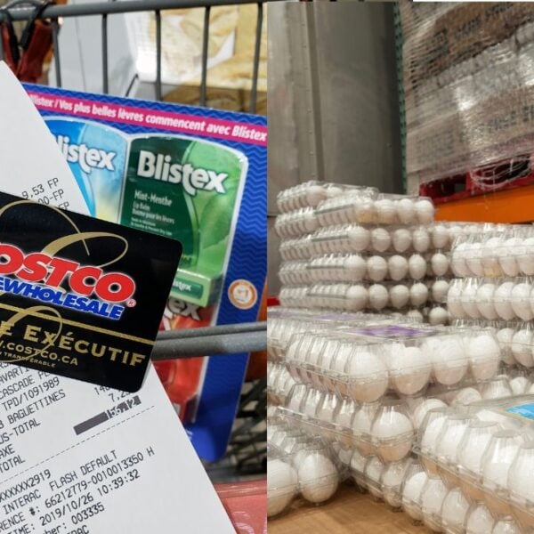 A hand holding a receipt and Costco Executive Membership card in Costco warehouse. Costco is an American corporation which operates a chain of warehouses.