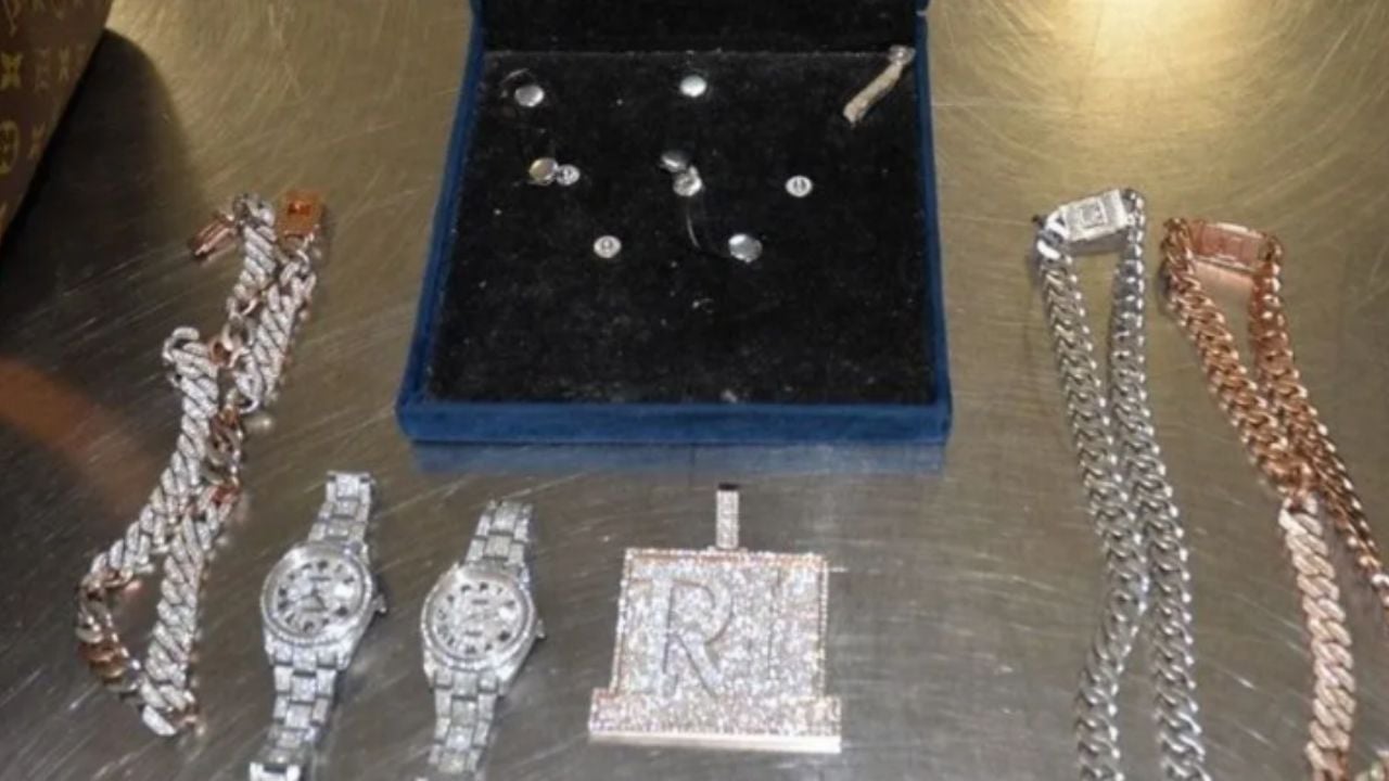 Luxury watches, chains, medallions and jewelry shown in the federal romance fraud investigation.
